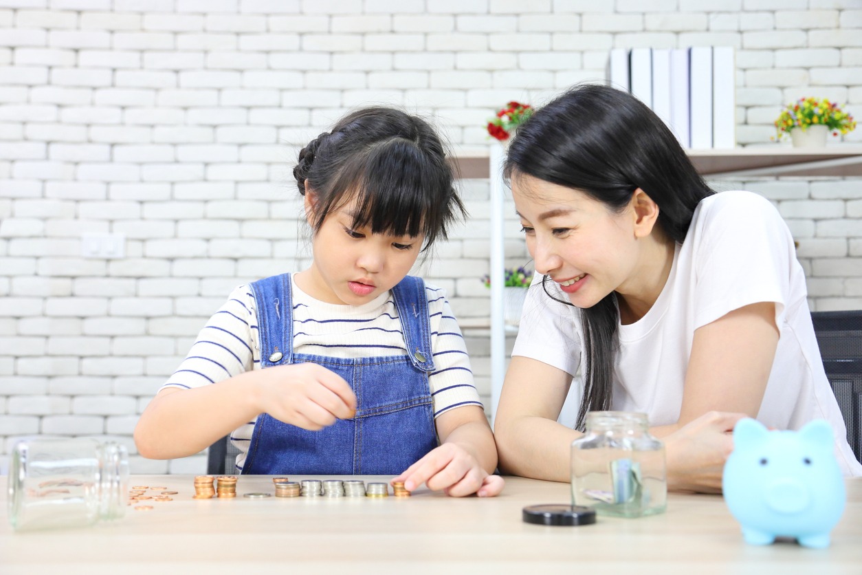 mother teaching daughter about saving