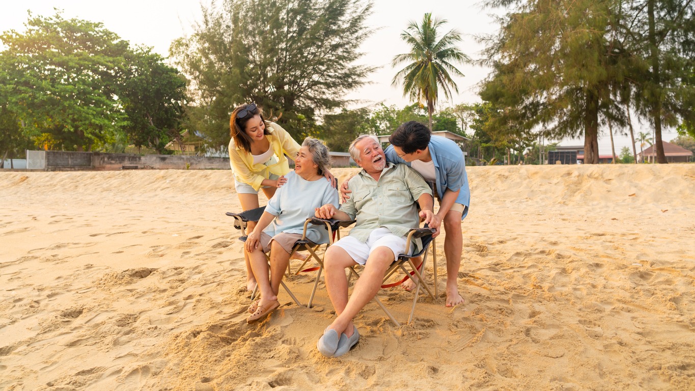 senior couple with children at the beach