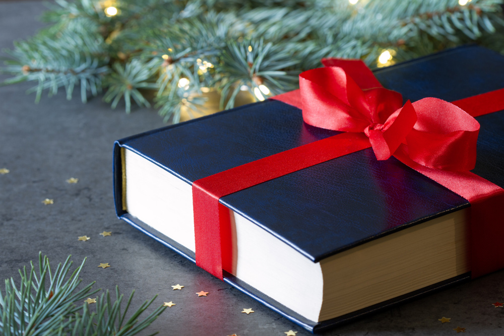 Book tied with red ribbon as Christmas