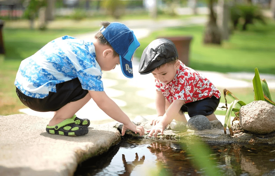 two kids playing with water