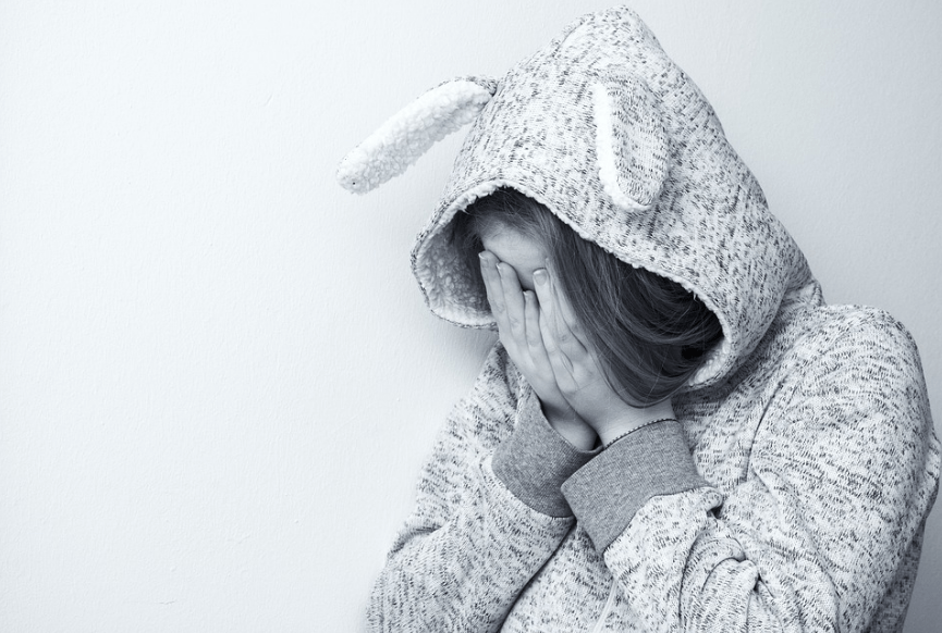 a girl covering her face