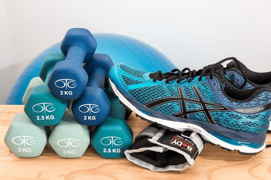 blue rubber shoes, pile of blue dumbbells, blue exercise ball