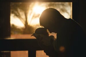 Father holding baby in dark