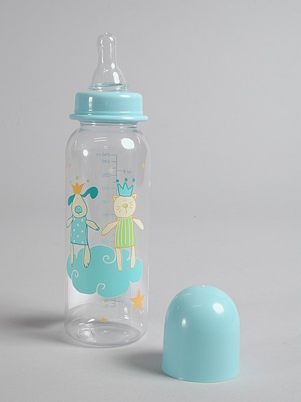 Transparent plastic feeding bottle with blue cap and silicone teat