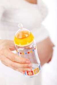 Woman holding a bottle feeder
