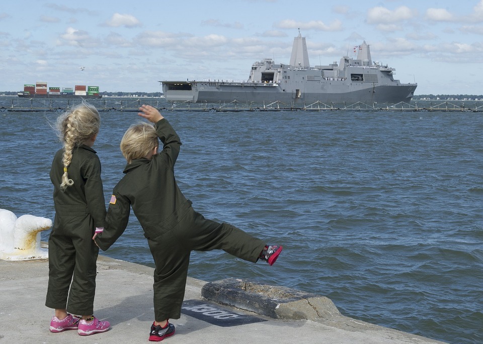 kids waving goodbye to the ship