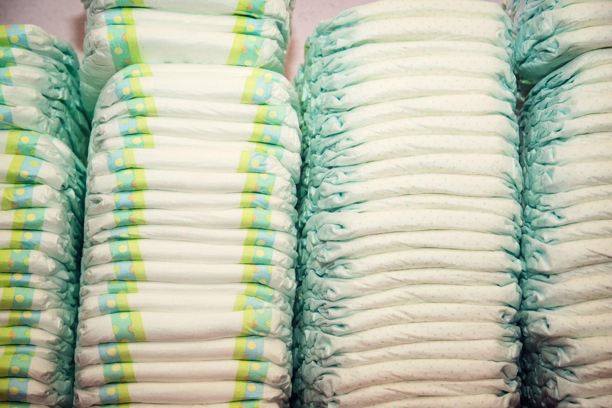 Children's diapers stacked in a many piles