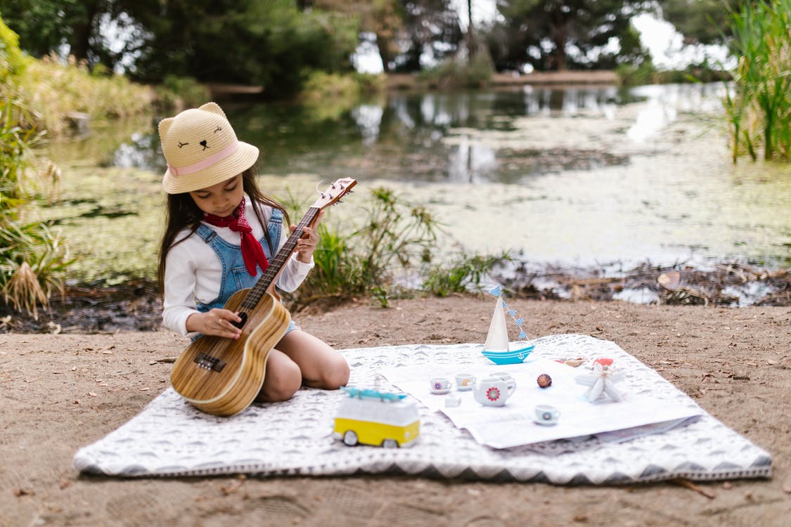 Allow your child to play with a toy musical instrument to keep her distracted during long travel on a vacation.