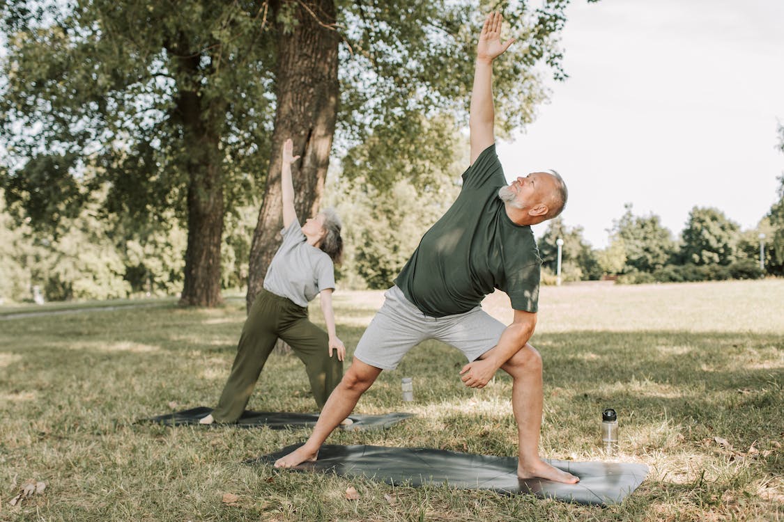 Old couple practicing yoga