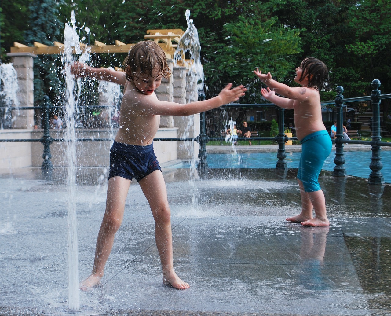 kids playing in the water fountain